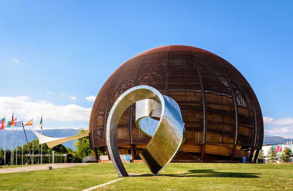 Meyrin, Switzerland - September 7, 2020: The steel ribbon titled "Wandering the Immeasurable" by Gayle Hermick and the Globe of Science and Innovation at CERN, the European Center for Nuclear Research