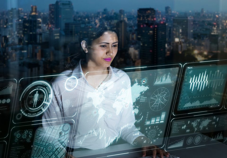 businesswoman looking at futuristic interface screen by Chombosan , Shutterstock